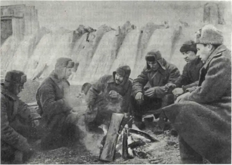 У костра На заднем плане разрушенная плотина Днепрогэса Октябрь 1943 г - фото 122