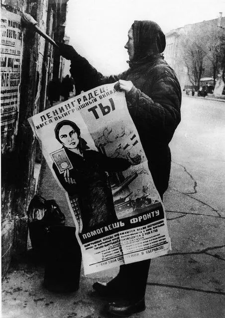 Женщина расклеивает агитационные плакаты в блокадном Ленинграде 1943 г - фото 244